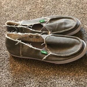 Sanuk slip on shoes.